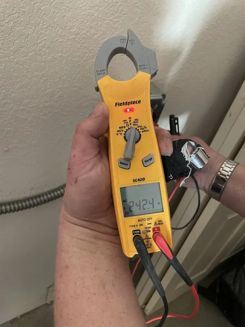 Voltage testing with clamp meter during Recessed Lighting Installation in Darby